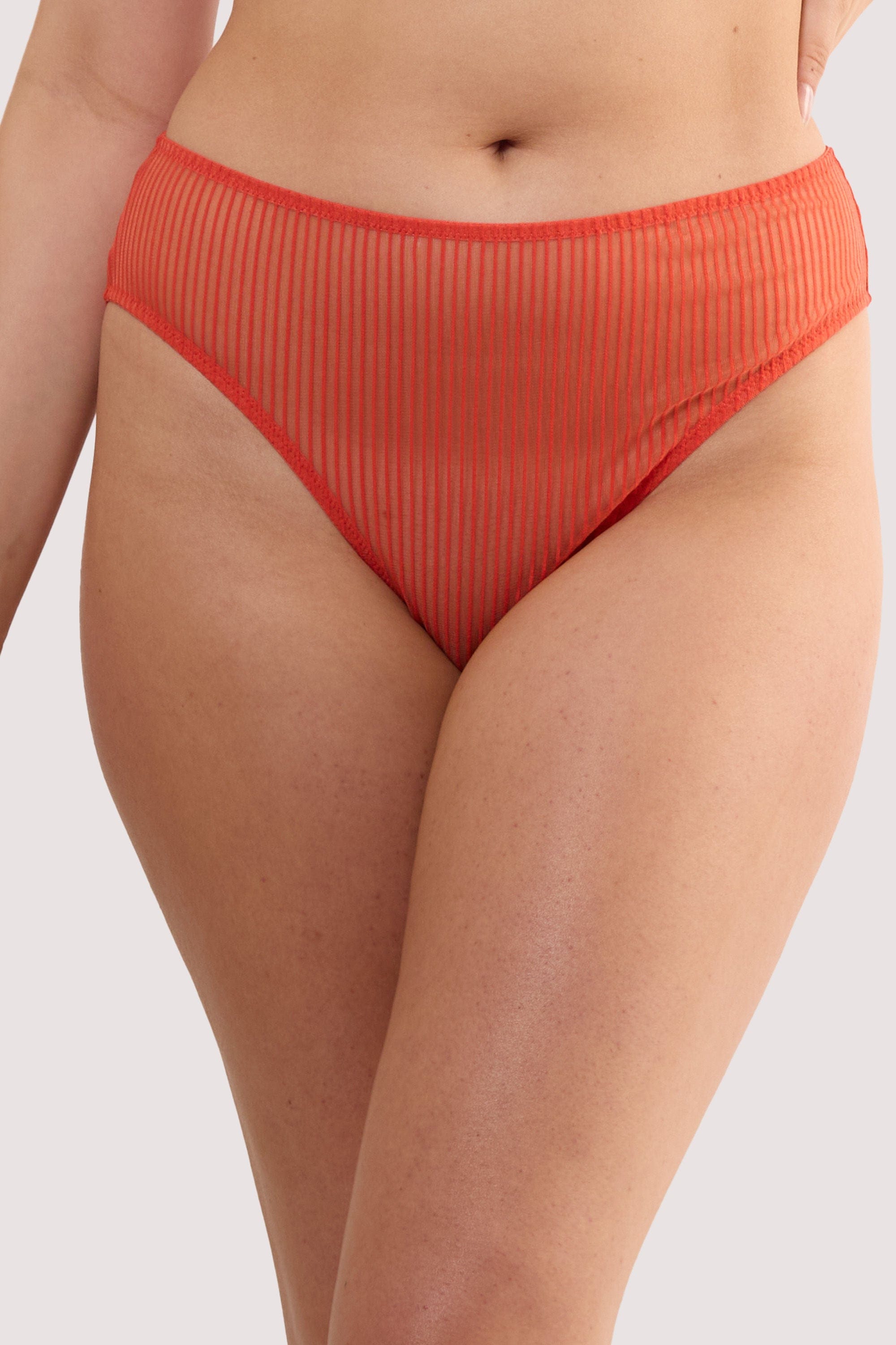 Model wears a veronica red microstripe hipster brief with red microstripe mesh.