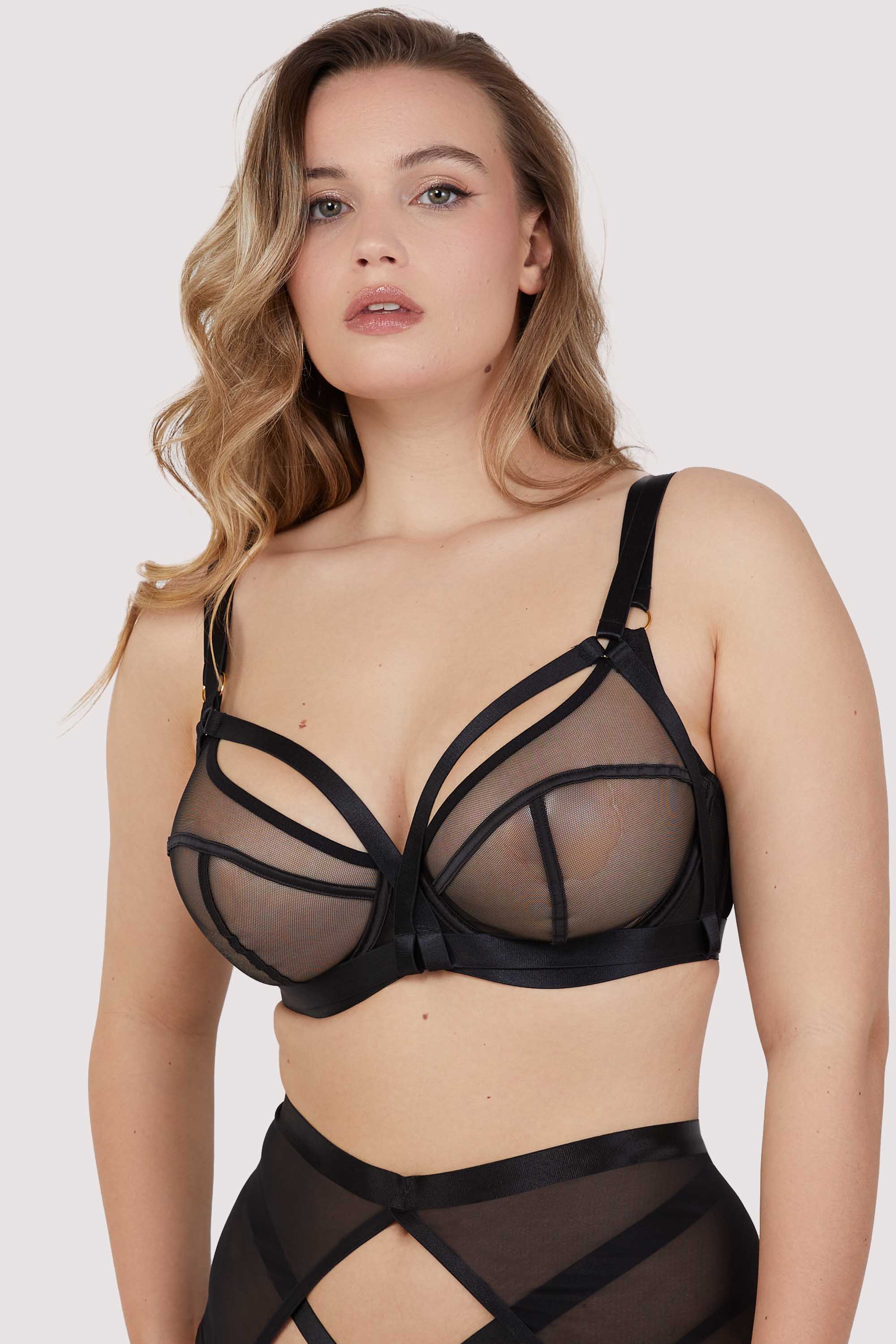 Model wears black balcony bra with matching Brazilian brief lingerie set