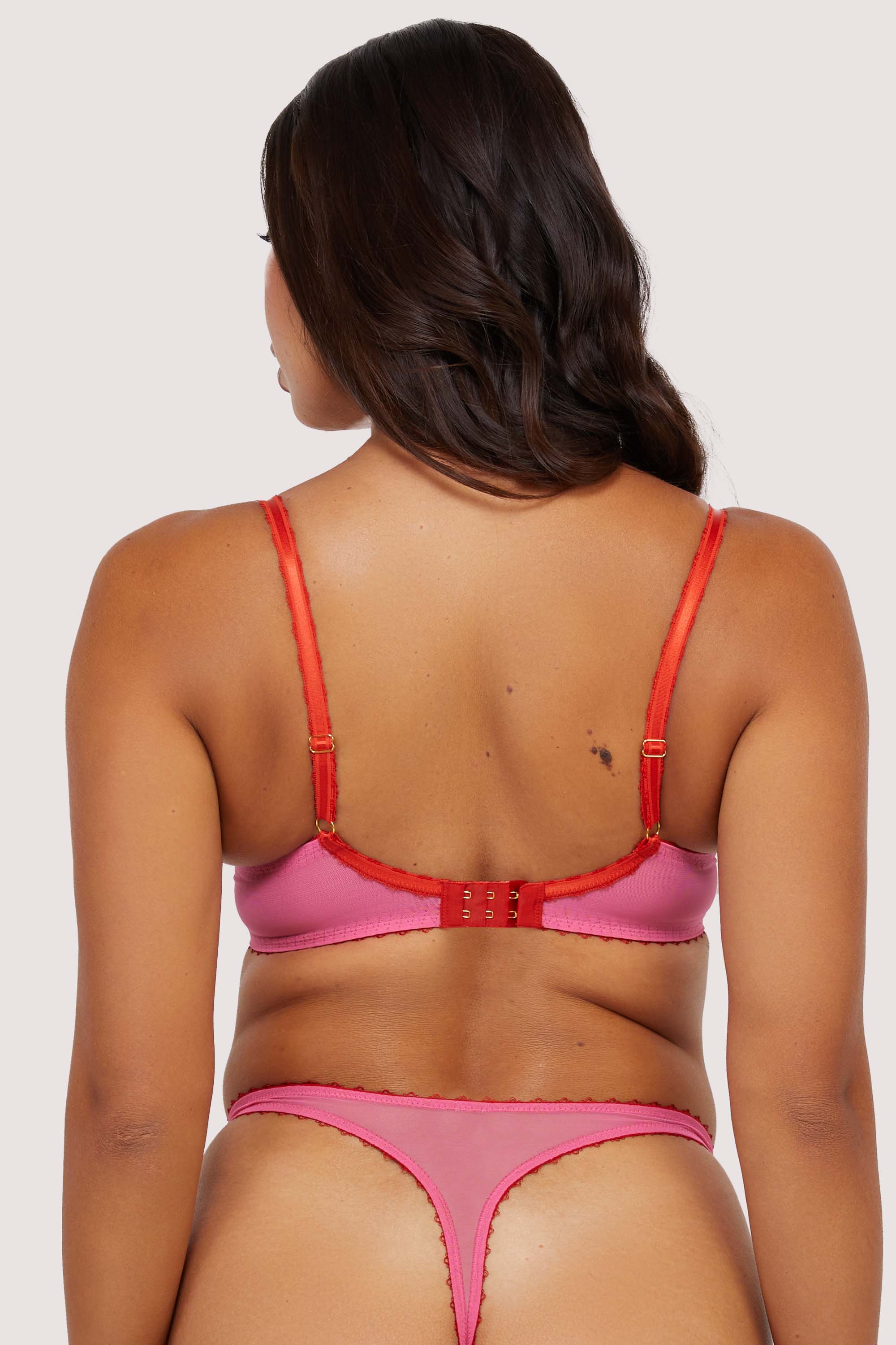 Model shows back of pink supportive plunge net bra with adjustable straps and hook-and-eye closure