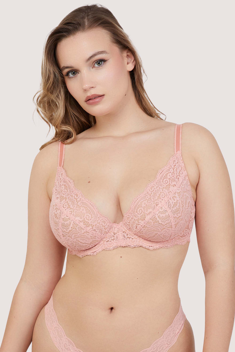 Model wears coral lace underwired bra with adjustable straps and gold hardware