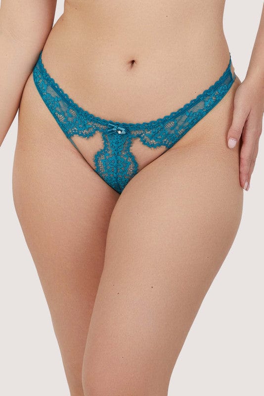 Model wears a teal eyelash lace brazillian brief with velvet bow with pearl charm and nude mesh with teal eyelash lace panels.