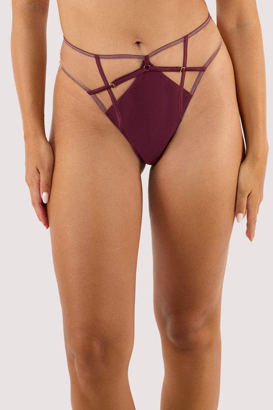 Model wears a wine high waist thong featuring a satin central panel, strap detailing, and gold metal hardware.