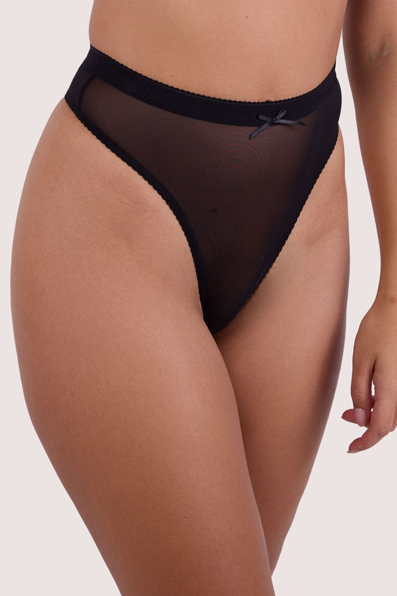 Model wears black mesh high waist thong with satin bow and sheer mesh panel.