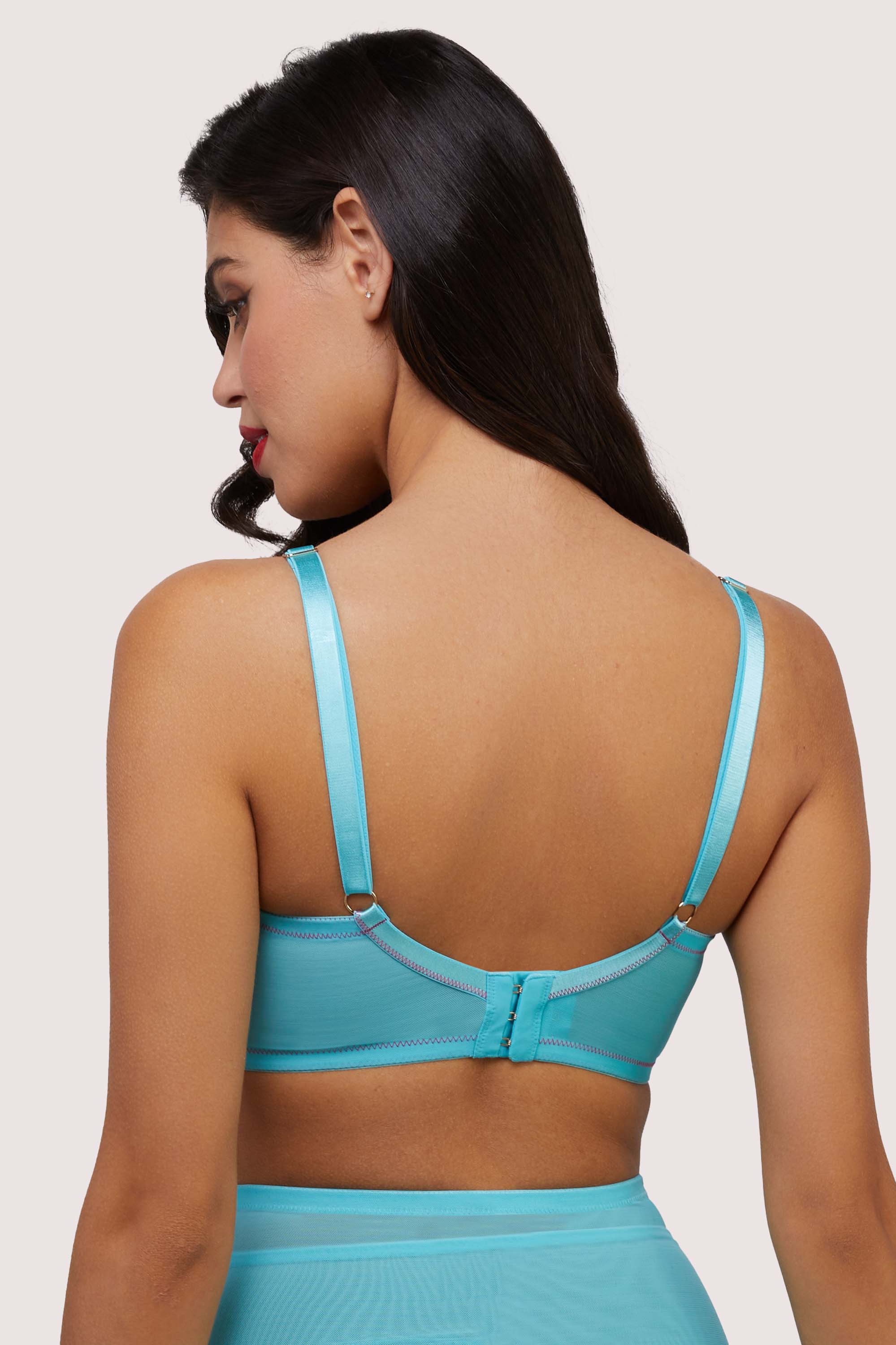 Model shows adjustable shoulder straps and hook and eye fastening back  of retro sky blue bullet bra