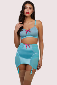 Model wears matching sky blue retro spiral stitch bullet bra and girdle with suspender straps