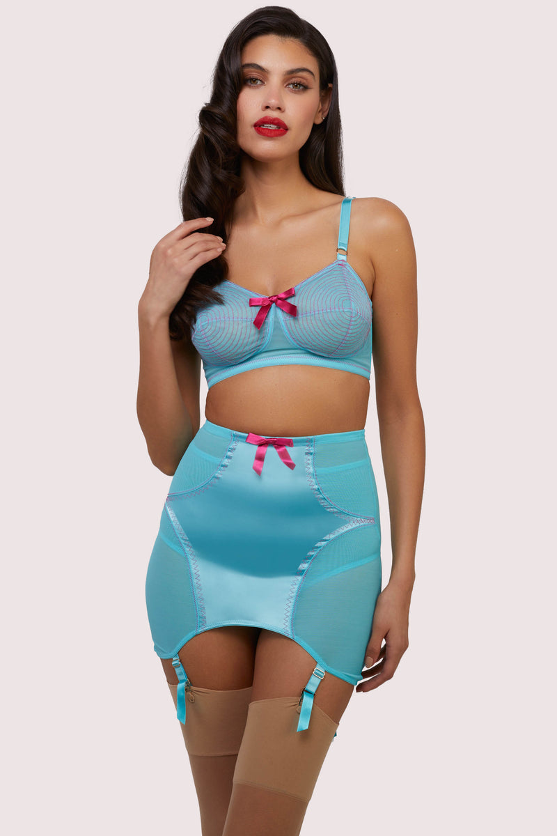 Model wears matching sky blue retro spiral stitch bullet bra and girdle with suspender straps