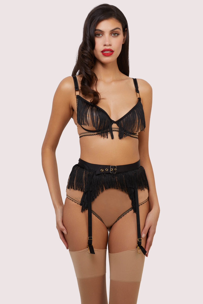 Model wears retro nude mesh and black fringe lingerie set