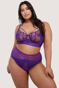 model wears purple bra and thong lingerie set with straps