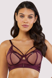 Harness style bra with mesh overlay and visible gold hardware in a deep wine red/purple.