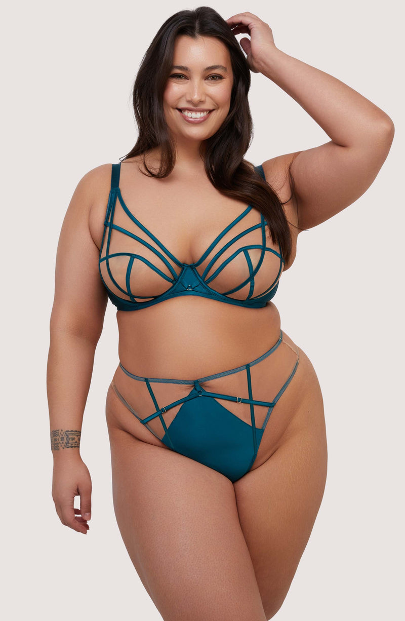 model wears teal bra and high waist thong lingerie set with straps