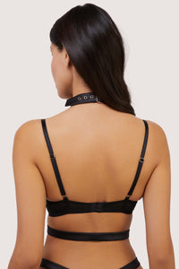 Model shows back view of hook and eye fastening bra with adjustable shoulder straps and buckle fastening choker harness
