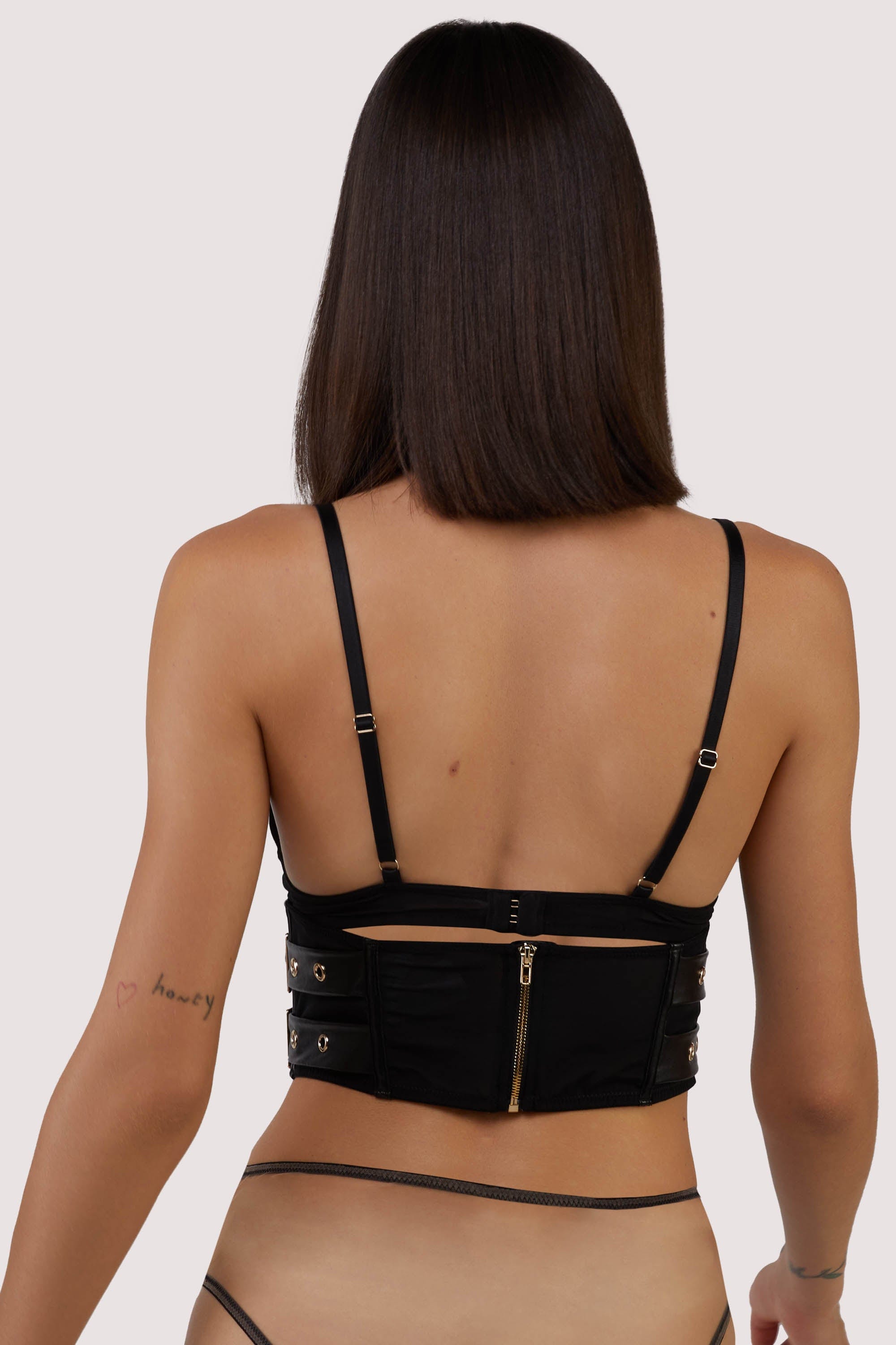 model shows black mesh zip fastening back of corset