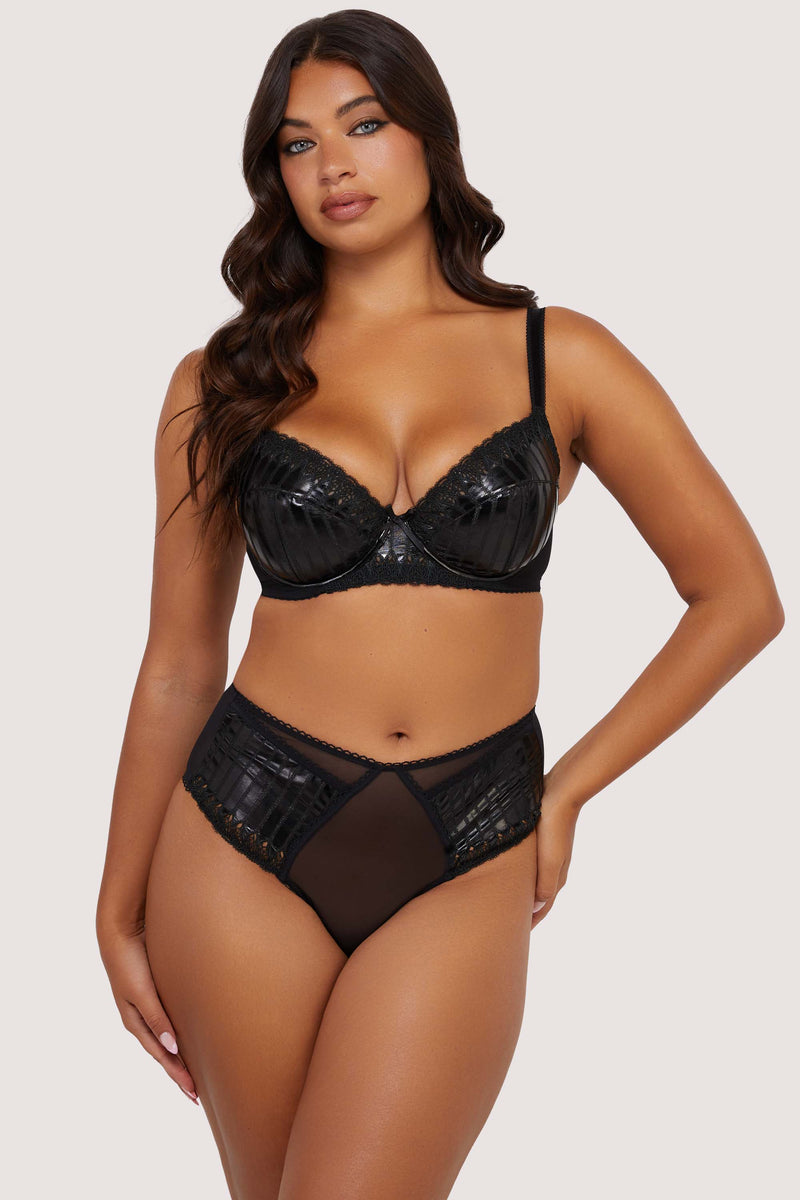 Model wears sexy black bra with straps and high waist brief