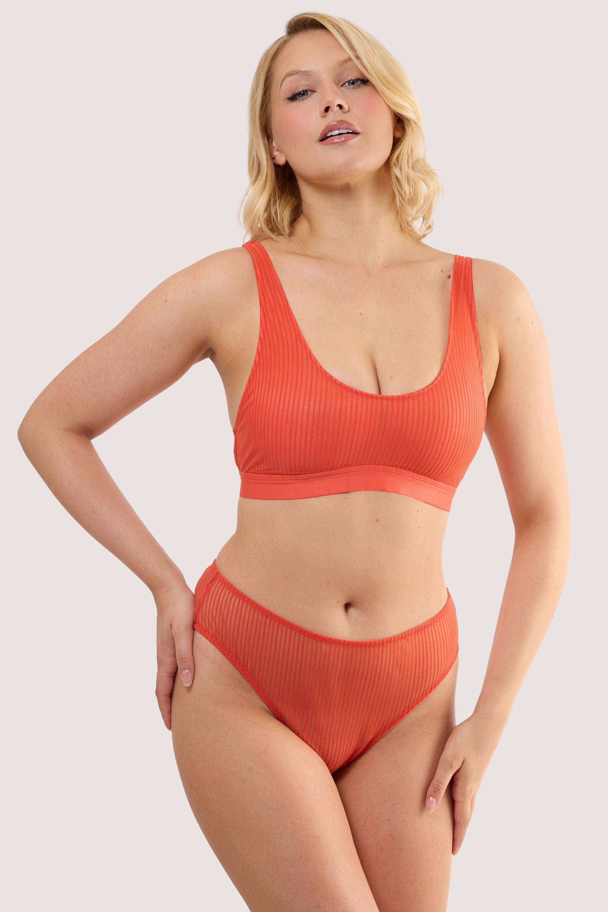 Model wears a veronica red microstripe crop bra with red microstripe mesh featuring soft crop-bra silhouette with matching high waist high leg brief