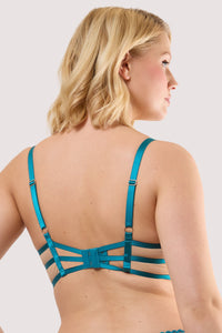 Model shows the back of a teal eyelash lace balconette bra with adjustable straps and hook and eye fastening back.