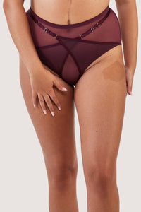 Harness style brief with mesh overlay and visible gold hardware in a deep wine red/purple.