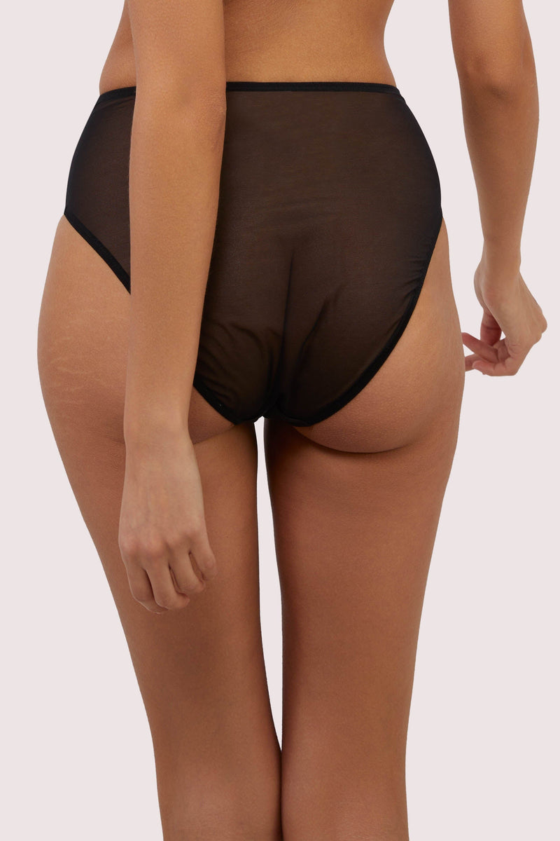 Model shows black mesh back of high-waist briefs