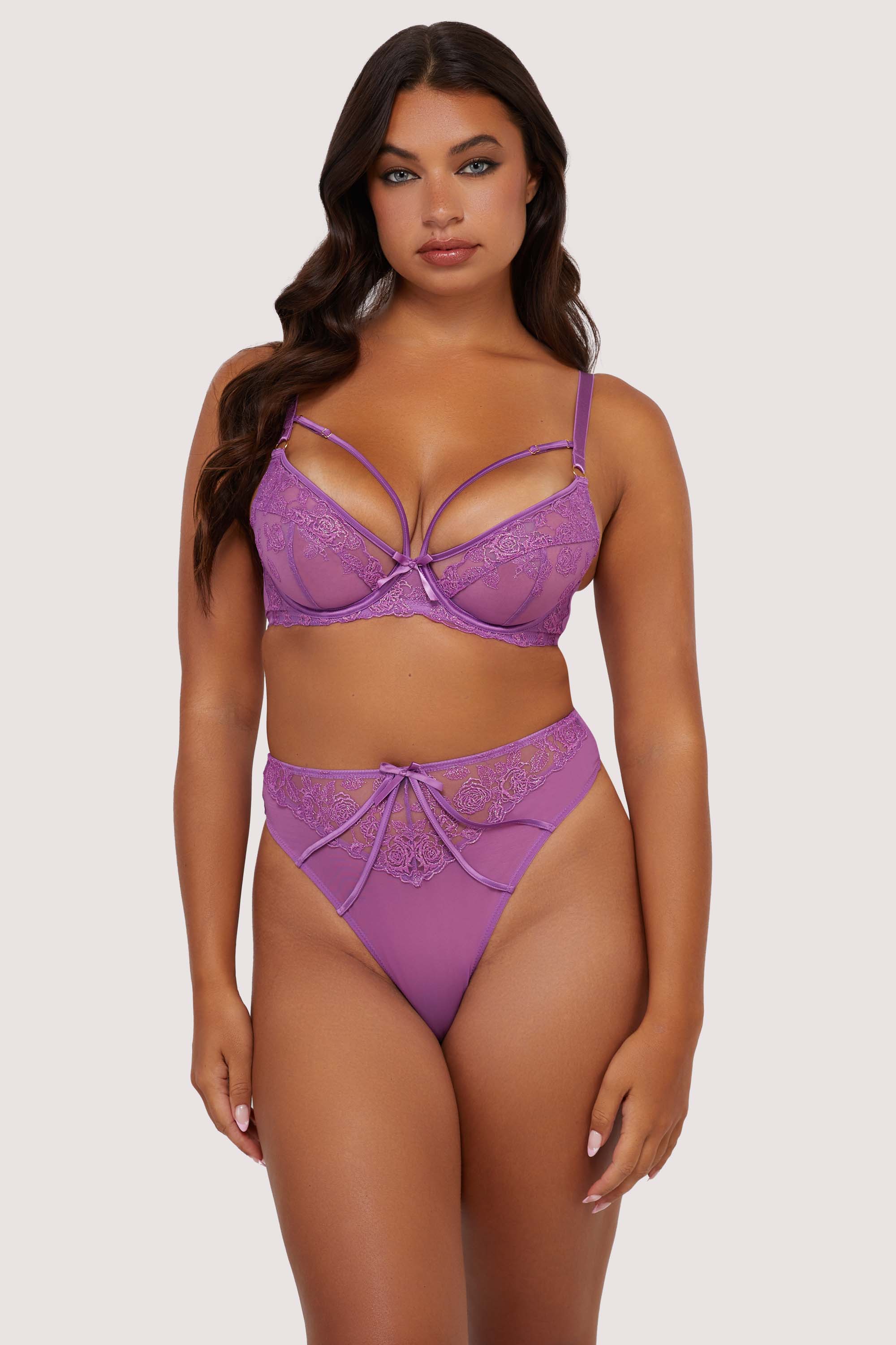 Model wears purple strappy lace plunge bra and high waist thong lingerie set