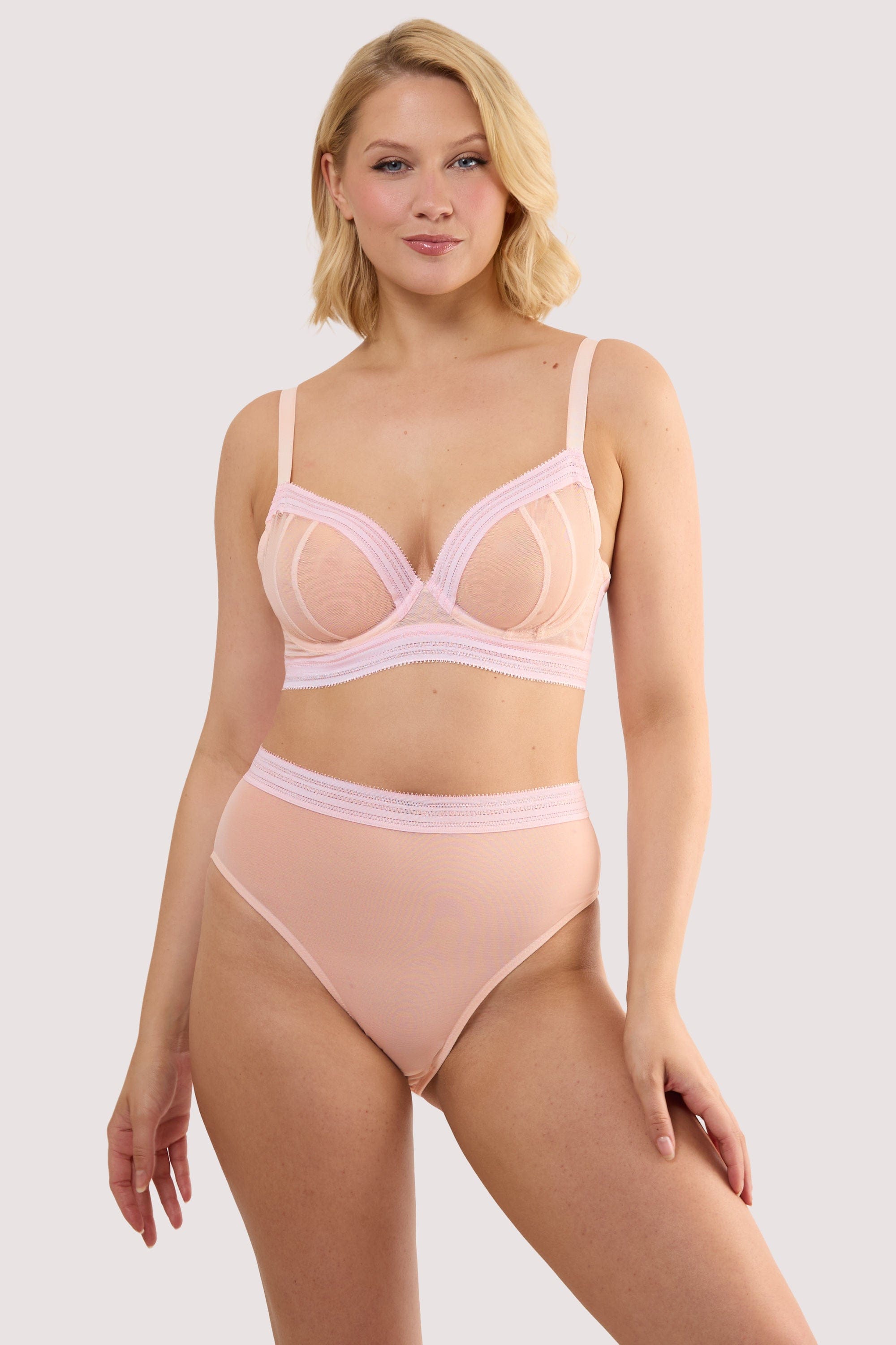 Model wears a icon blush pink high waist brief with light pink supportive mesh with a matching bra.