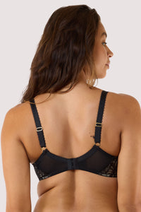 Model wears Black Lace Balconette Bra and matching lace thong with sheer lace, balconette cups, blush-pink satin rose detail