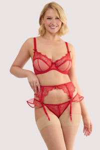 Model wears a monica red ribbon slot lace suspender with sheer mesh panels with bow and rose accents, and red lace with ribbon slot detailing, with a matching bra and thong.