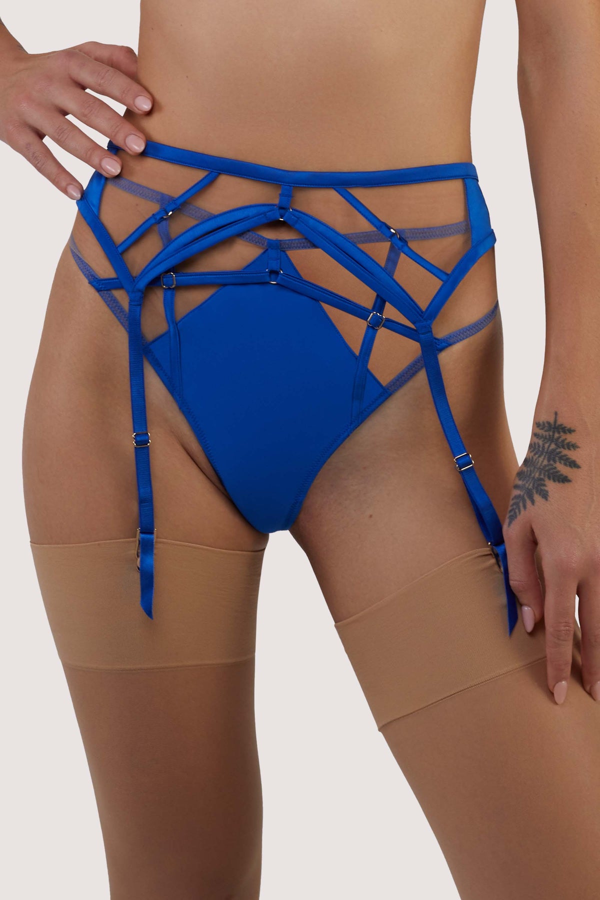 model wears cobalt blue suspender belt