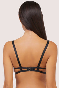 Model shows caged back and hook and eye fastener of sheer mesh bra