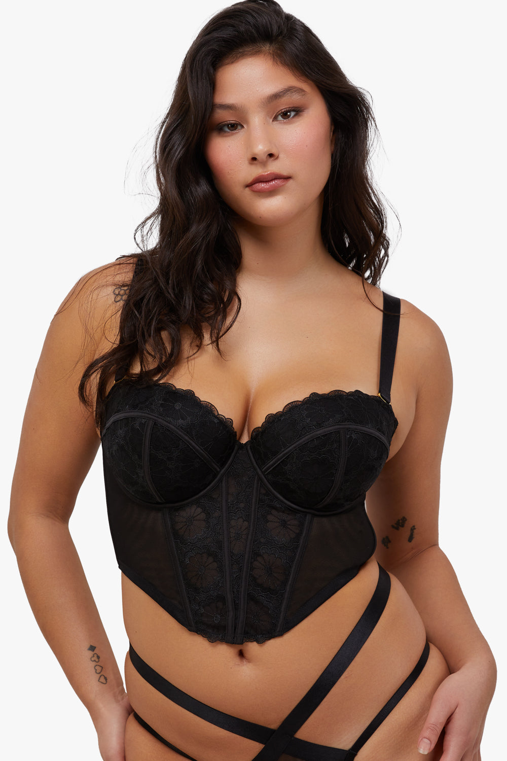 Model wears black embroidered mesh boned  bustier with removable shoulder straps and underwire cups