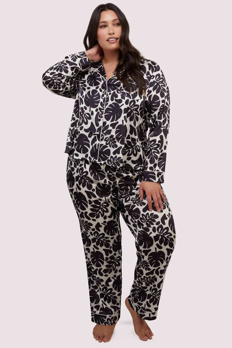 model wears black and white leaf print pyjamas