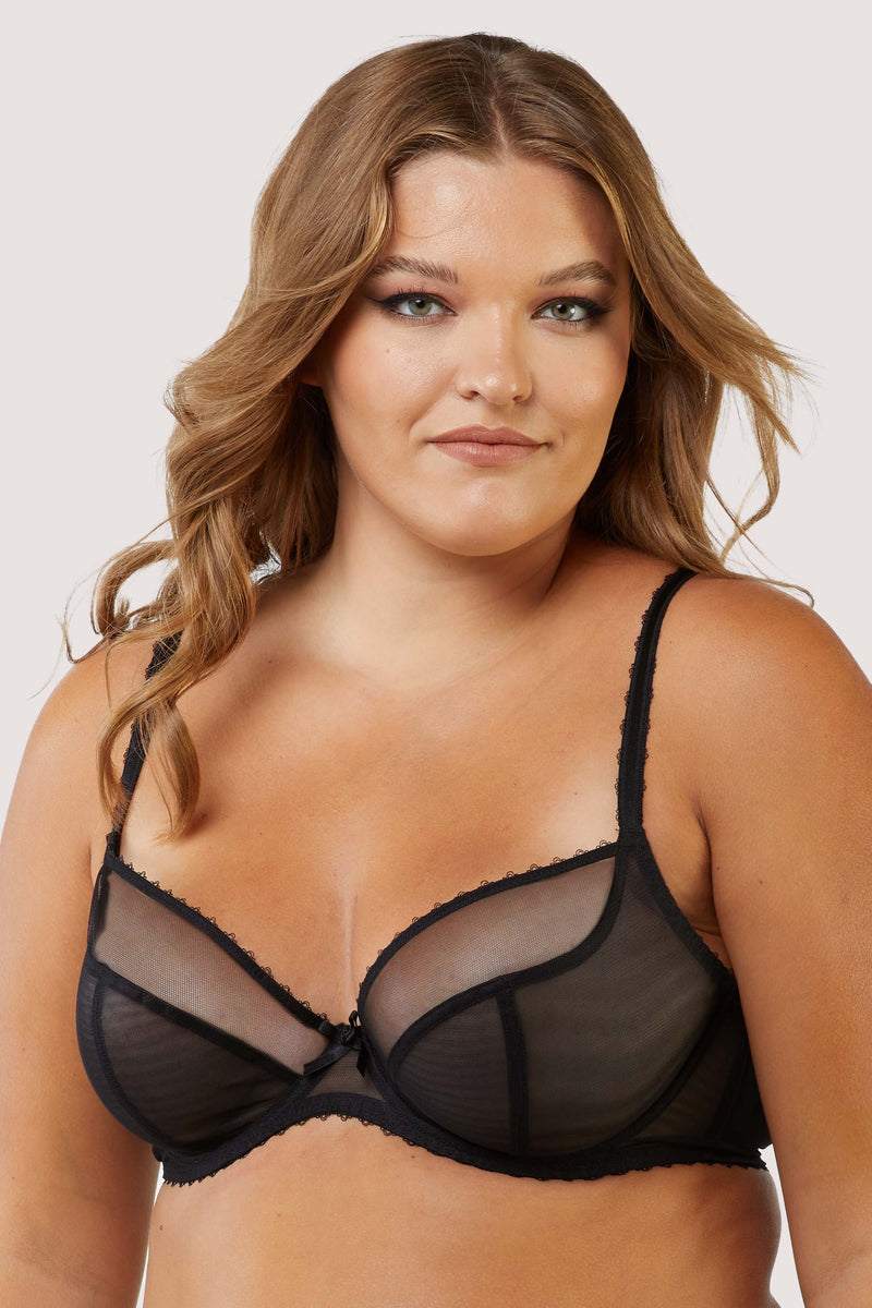 Model Wears black plunge mesh bra showcasing its sheer cups and elegant bow detail.