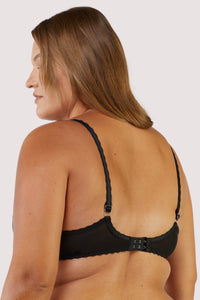 Model in black mesh bra and panties, featuring underwire support and adjustable straps, exuding comfort and style.