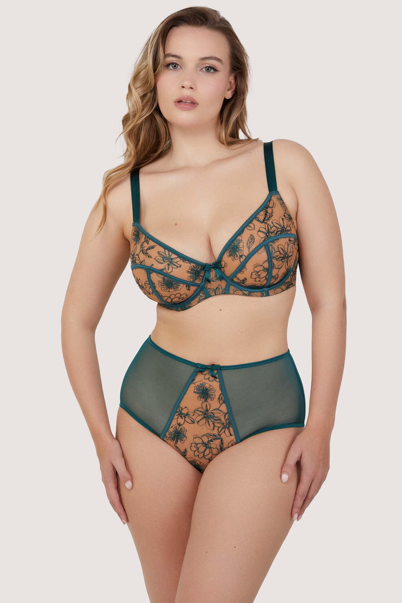 Model wears teal contrast embroidery balconette bra and high waisted brief set featuring nude mesh and teal floral detailing