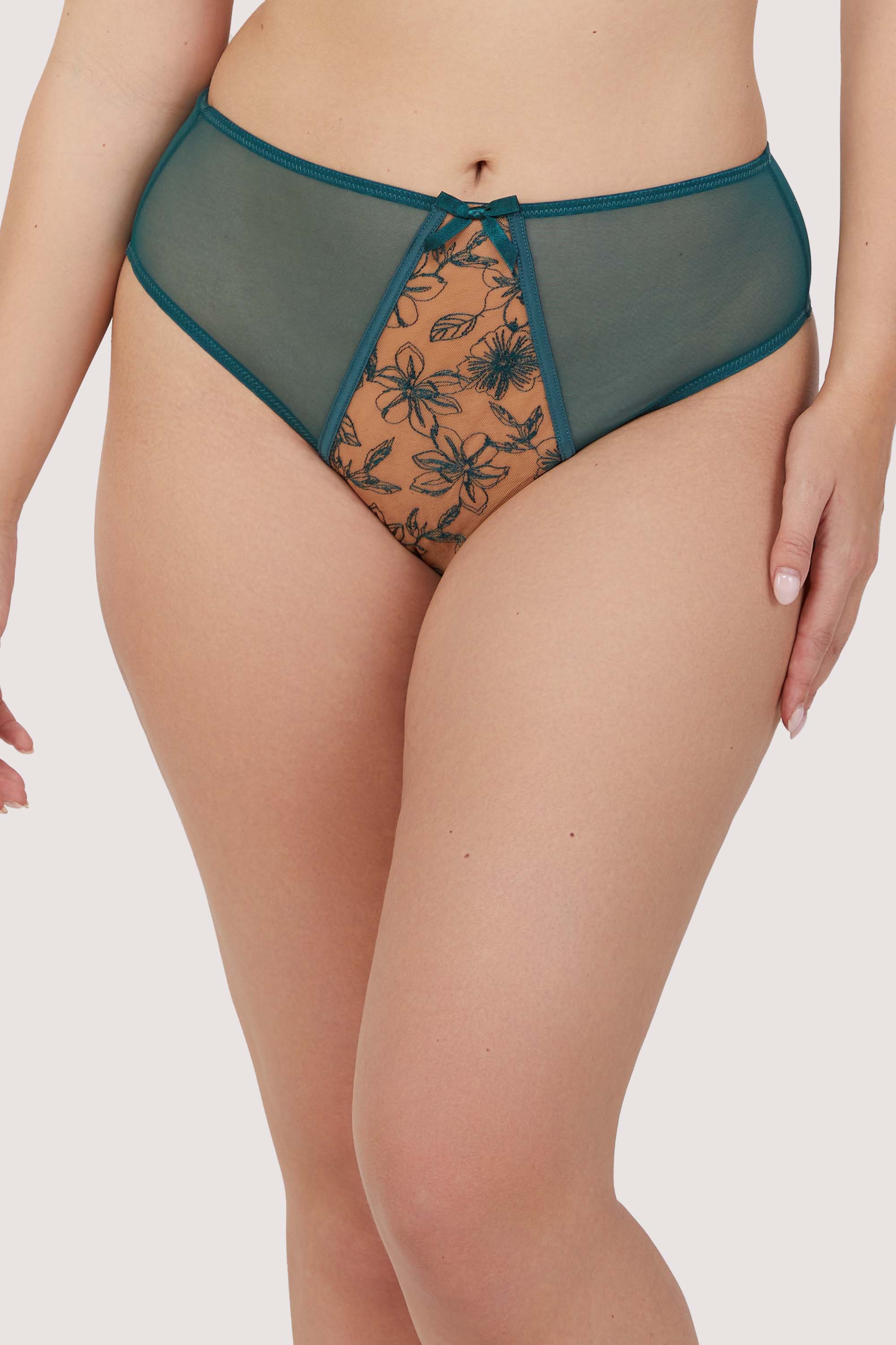Model wears teal contrast embroidery balconette bra with underwire plunge cups, nude mesh, and teal floral embroidery, featuring thick adjustable straps and satin seam detailing