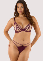 Fuller Bust|Model wears a wine thong featuring a satin central panel, strap detailing, and gold metal hardware with a matching wine plunge bra.